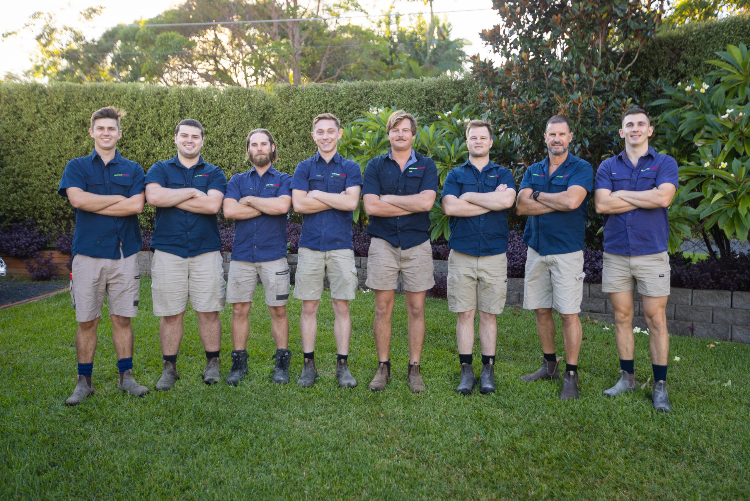 The Electric Express Solutions team photo of 8 Electricians including Level 2 Electricans who service the [suburb] area smiling at the camera